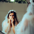 A bride crying inside a bathroom