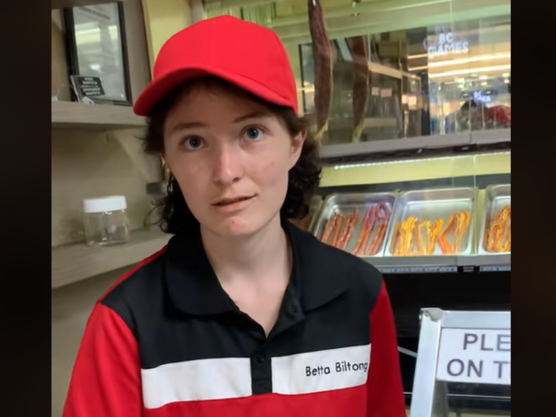 A woman wearing a uniform serving biltong looks shocked