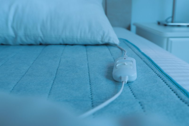 Bed with electric heating pad