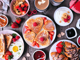 Heart shaped pancakes on a dark wooden table